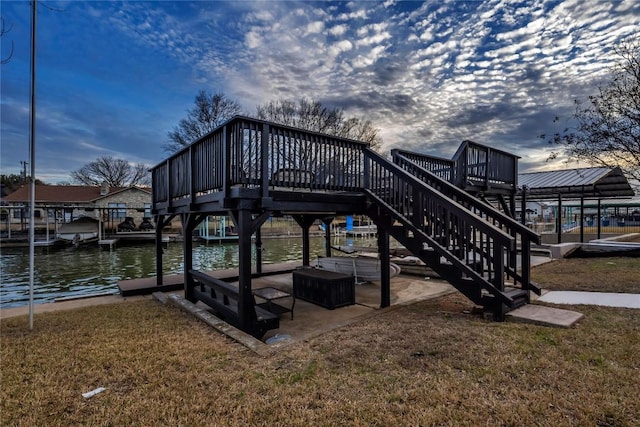 dock area with a deck, a yard, stairway, and a patio