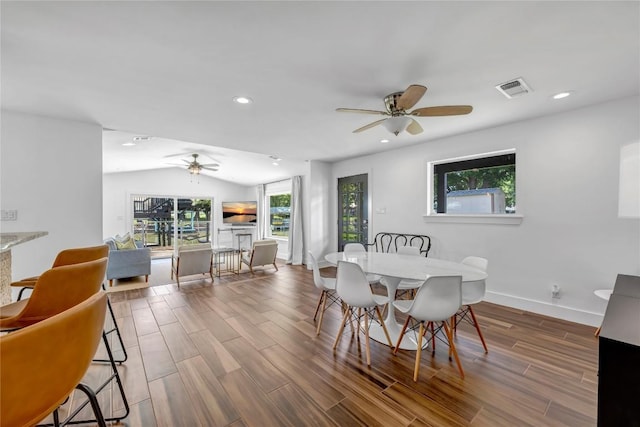 dining area featuring recessed lighting, visible vents, vaulted ceiling, wood finished floors, and baseboards