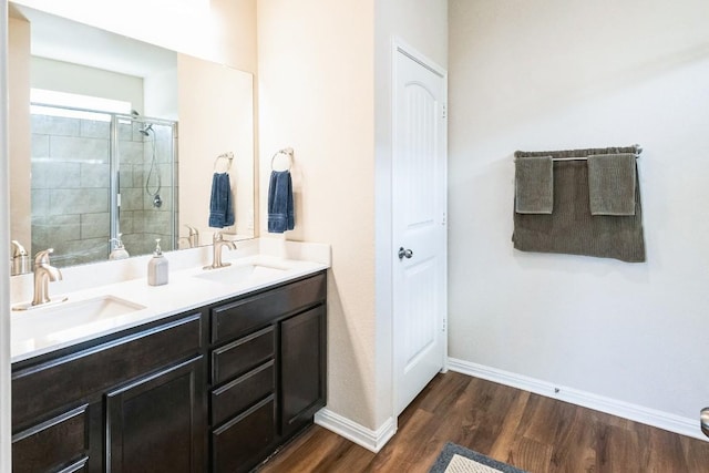4337 Buffalo Ford Rd, Georgetown, TX 78628 - bathroom with wood finished floors, double vanity, baseboards, and a tile shower
