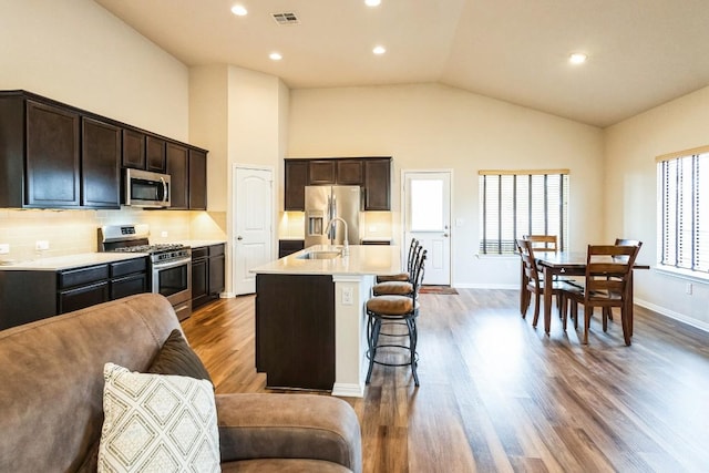 4337 Buffalo Ford Rd, Georgetown, TX 78628 - kitchen with stainless steel appliances, a sink, light countertops, an island with sink, and a breakfast bar
