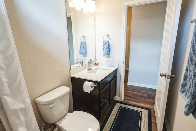 4337 Buffalo Ford Rd, Georgetown, TX 78628 - bathroom with toilet, wood finished floors, vanity, and baseboards