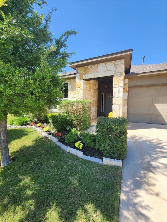 4337 Buffalo Ford Rd, Georgetown, TX 78628 - view of front facade featuring stone siding, an attached garage, concrete driveway, and a front yard