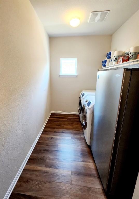 4337 Buffalo Ford Rd, Georgetown, TX 78628 - washroom with washer and clothes dryer, baseboards, and wood finished floors