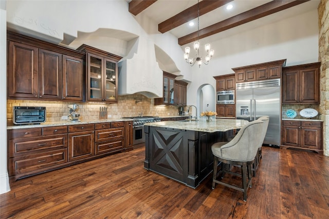 19520 Tessa Hts, Spicewood, TX 78669 - kitchen featuring built in appliances, beam ceiling, a chandelier, dark wood-type flooring, and a sink