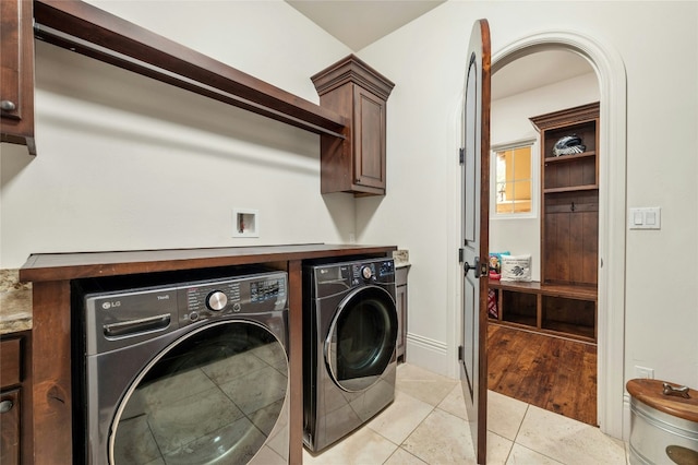 19520 Tessa Hts, Spicewood, TX 78669 - washroom featuring cabinet space, washer and dryer, and light tile patterned flooring