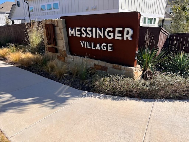 community / neighborhood sign with fence