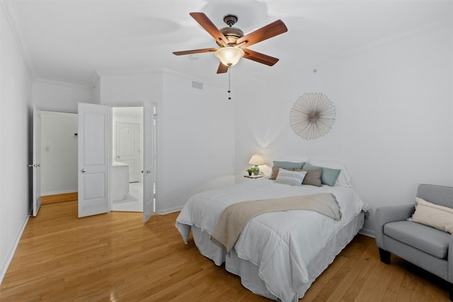 bedroom with baseboards, visible vents, a ceiling fan, ornamental molding, and light wood-style floors