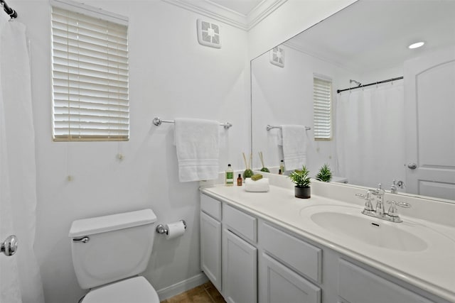 bathroom with toilet, baseboards, ornamental molding, and vanity