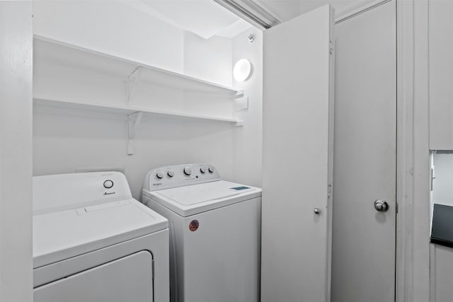 clothes washing area with laundry area and washer and clothes dryer