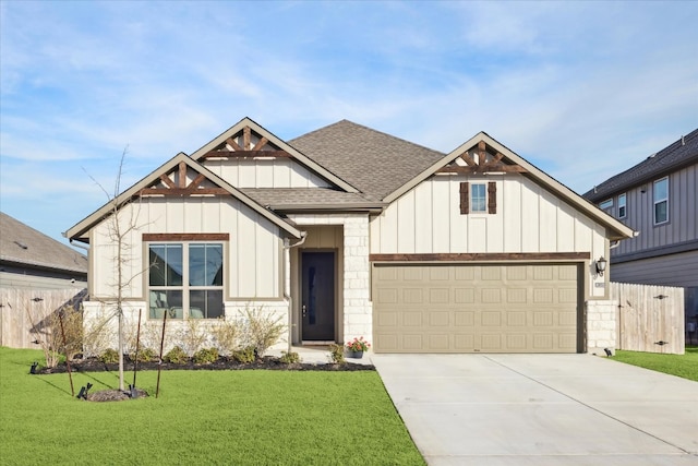 view of front of house with board and batten siding, a front yard, concrete driveway, and roof with shingles