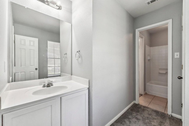 bathroom featuring baseboards, visible vents, vanity, and tile patterned floors