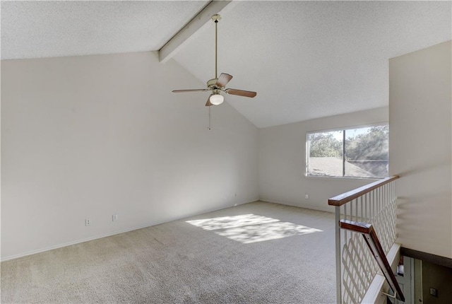 unfurnished room featuring carpet, ceiling fan, lofted ceiling with beams, and a textured ceiling