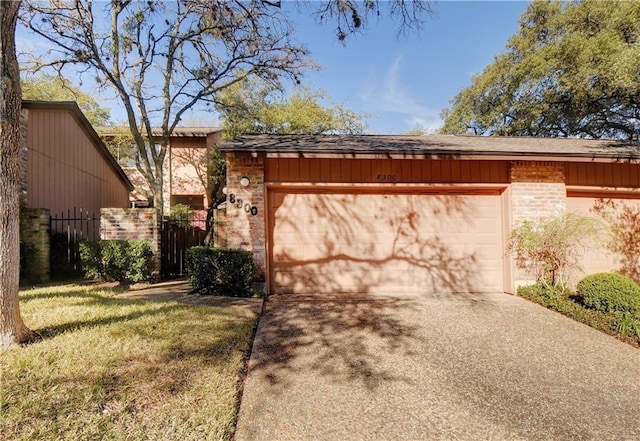 view of home's exterior featuring an attached garage, concrete driveway, and brick siding