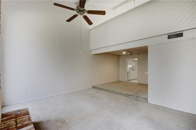 spare room featuring carpet flooring, ceiling fan, and visible vents