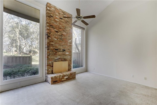 unfurnished living room featuring vaulted ceiling, ceiling fan, and carpet