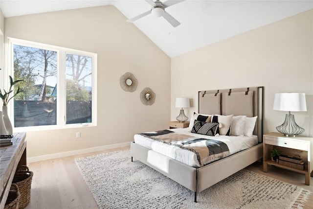 bedroom featuring high vaulted ceiling, a ceiling fan, light wood-style flooring, and baseboards