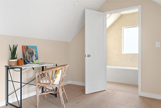 home office featuring vaulted ceiling, wood finished floors, and baseboards