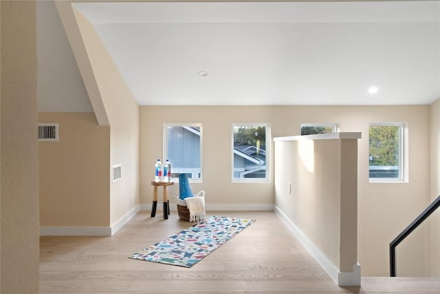 foyer featuring light wood-type flooring, visible vents, and baseboards