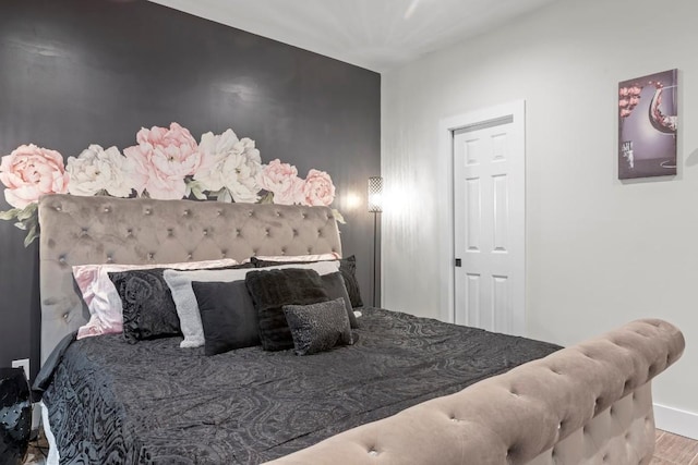 bedroom with wood finished floors and baseboards