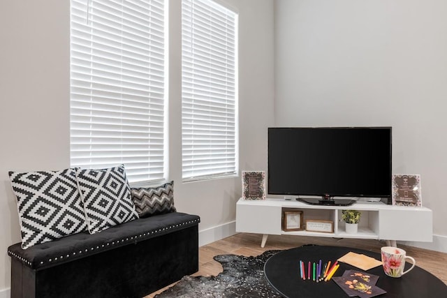 living room featuring baseboards and wood finished floors