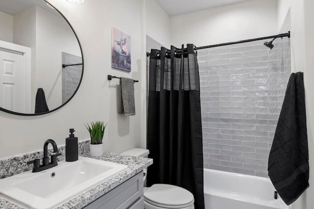 full bath with shower / tub combo, vanity, and toilet