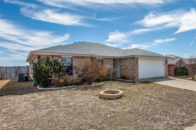 ranch-style house with cooling unit, a garage, brick siding, fence, and concrete driveway