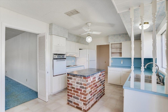 kitchen with ceiling fan, white appliances, a sink, visible vents, and open shelves