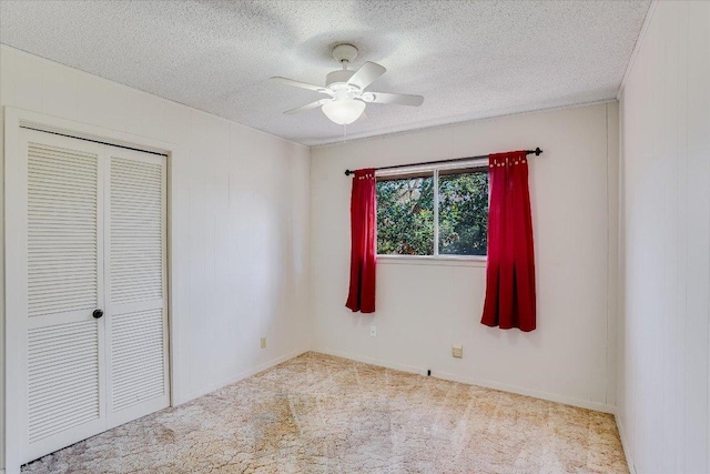 unfurnished bedroom featuring carpet, a closet, ceiling fan, and a textured ceiling