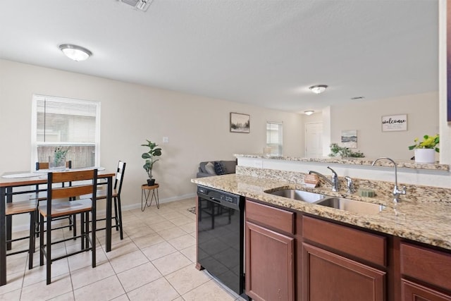 kitchen with dishwasher, light tile patterned floors, plenty of natural light, and a sink