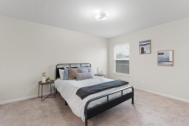 bedroom featuring baseboards and light colored carpet