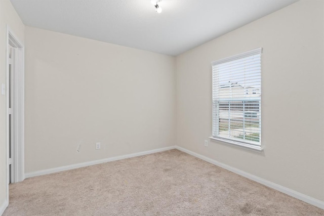 empty room with carpet floors and baseboards