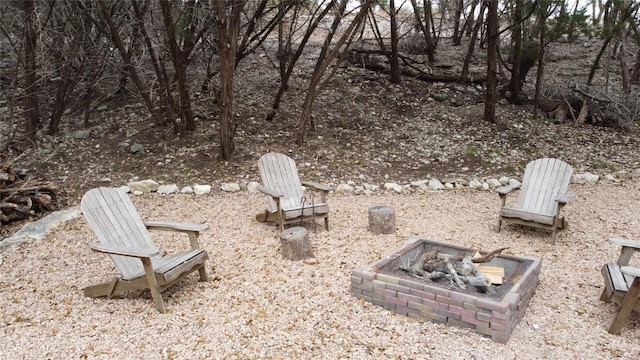 view of yard featuring an outdoor fire pit