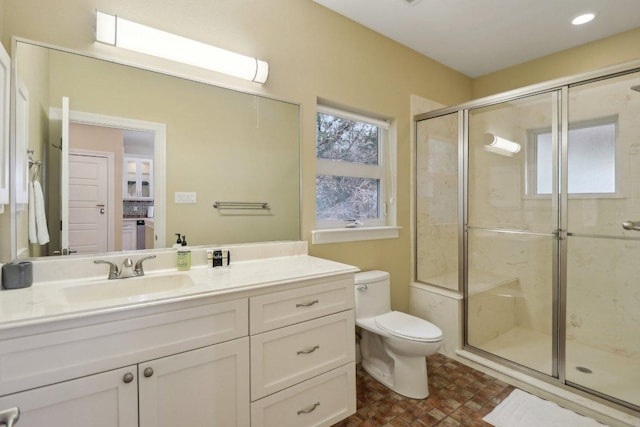 full bath with a shower stall, toilet, and vanity