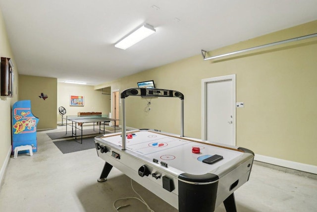 playroom with concrete floors and baseboards