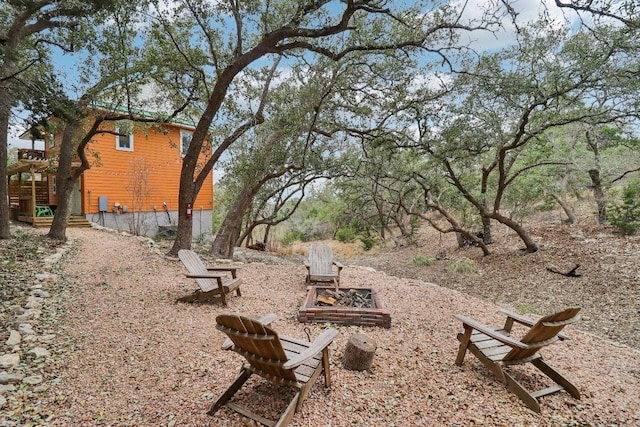 view of yard with stairway and an outdoor fire pit