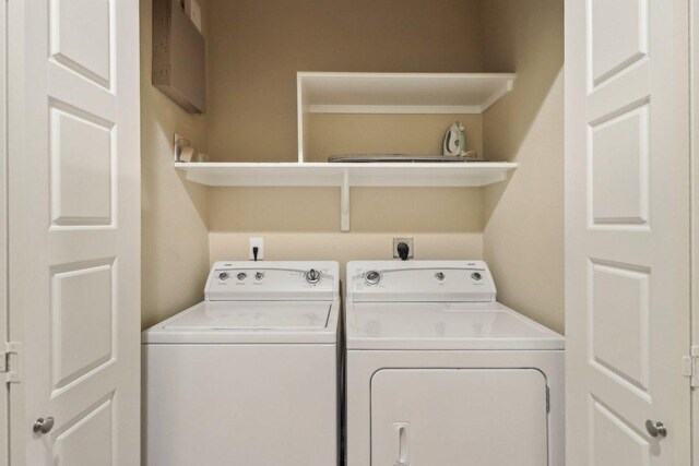 washroom with washer and clothes dryer and laundry area