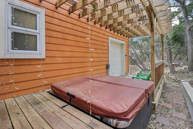 wooden deck with a covered hot tub