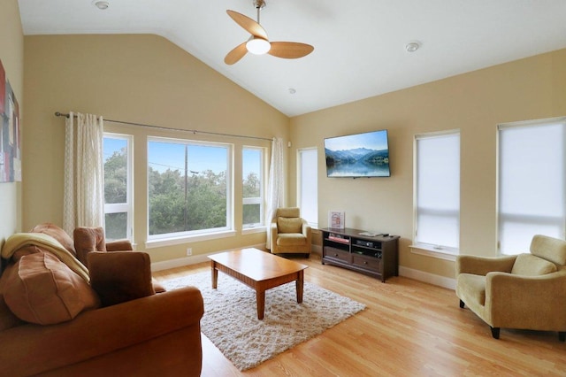 living room with high vaulted ceiling, baseboards, a healthy amount of sunlight, and light wood finished floors