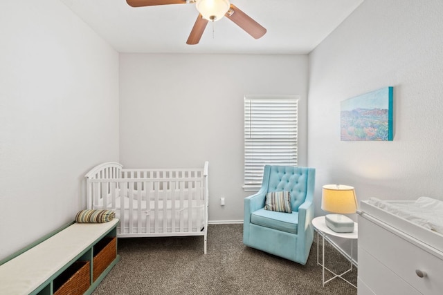 bedroom featuring a crib, carpet, and ceiling fan