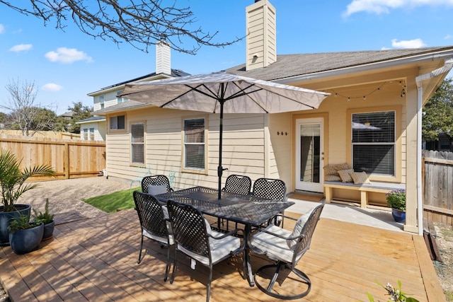 deck with outdoor dining space and fence