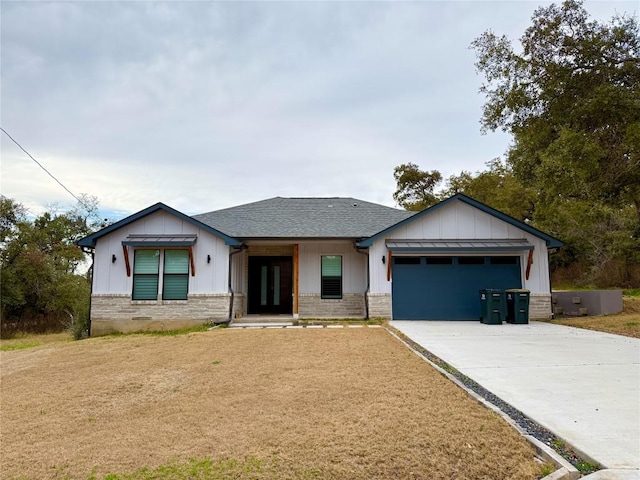 view of front of home with roof with shingles, brick siding, concrete driveway, an attached garage, and board and batten siding