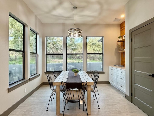 dining space featuring a chandelier, visible vents, and baseboards