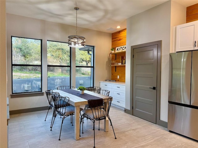 dining space with recessed lighting, a notable chandelier, and baseboards