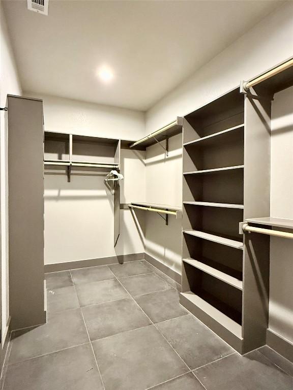 spacious closet with tile patterned floors