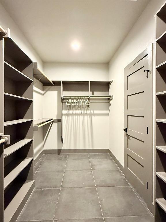 spacious closet with tile patterned floors