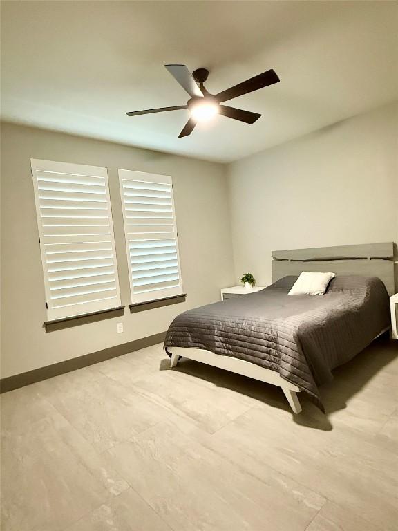 bedroom featuring a ceiling fan and baseboards