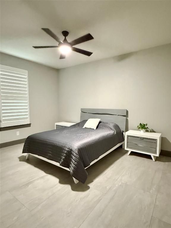 bedroom featuring a ceiling fan and baseboards