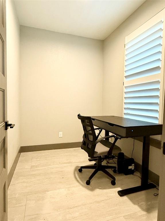 office space featuring baseboards and wood finished floors