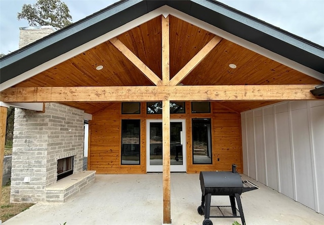 view of patio / terrace featuring an outdoor brick fireplace