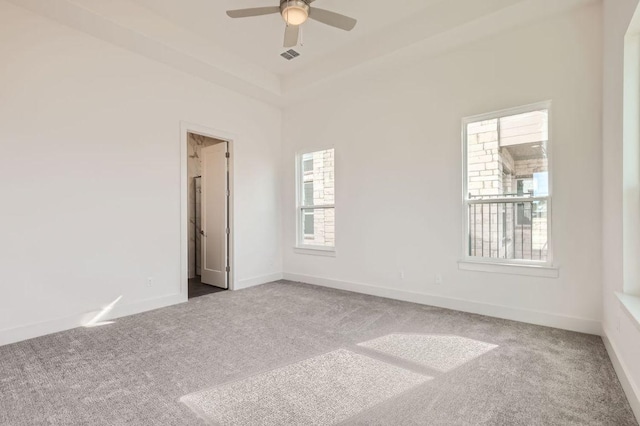 unfurnished room featuring carpet floors, visible vents, and baseboards